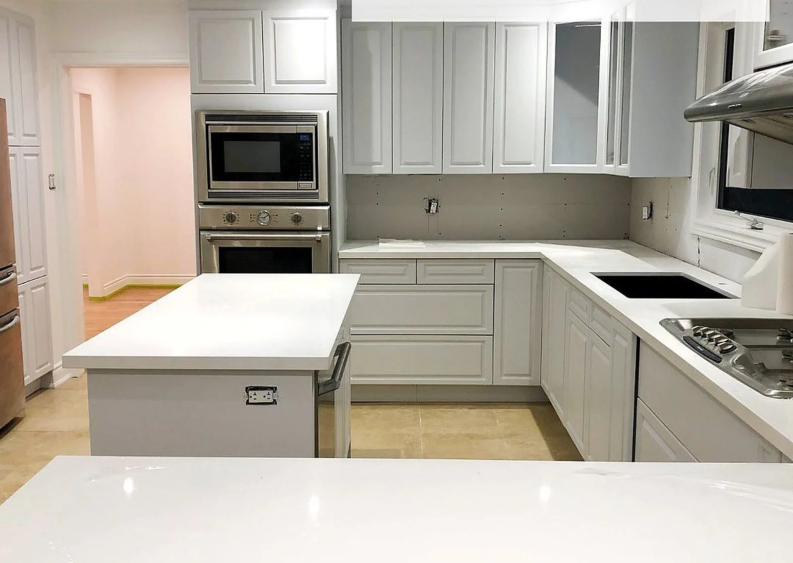 After: Oak cabinets, sprayed white