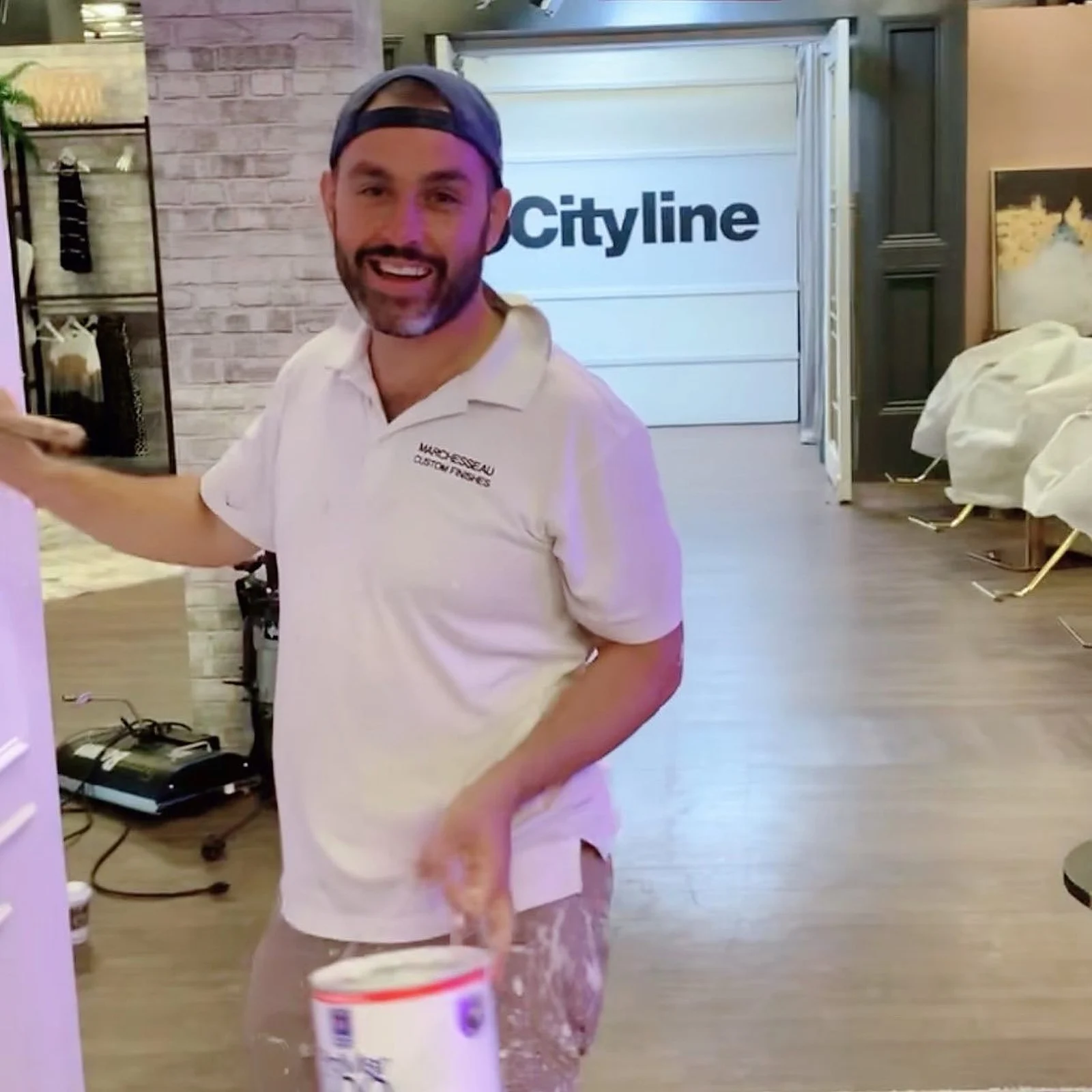 Paul Marchesseau smiling on the Cityline set, holding a paint can